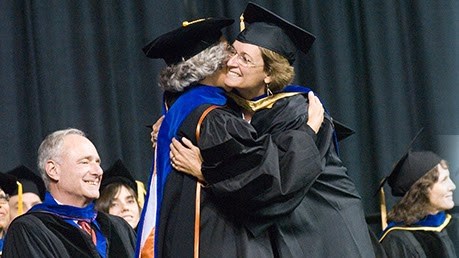 Graduating people hugging